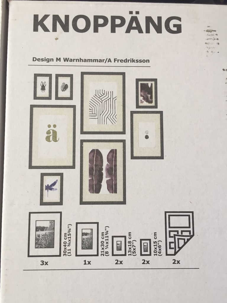 Close up of the white box with an arrangment of black photo frames